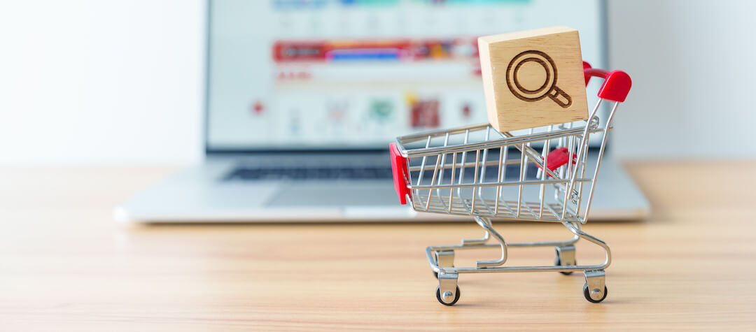 shopping-cart-with-magnifying-icon-block-and-laptop